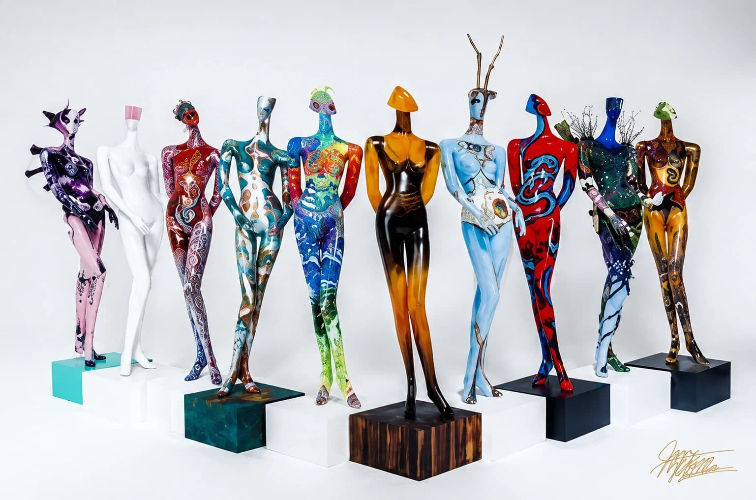 A row of full-size hand-painted mannequins displayed on pedestals