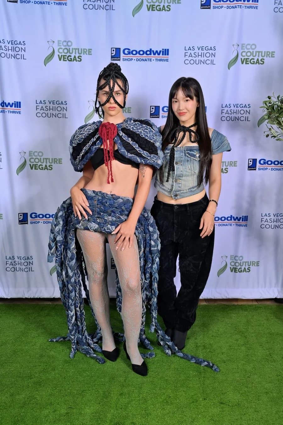 Min Suh Lim's first-place design at Eco Couture Vegas 2026, in front of the event's sponsor wall